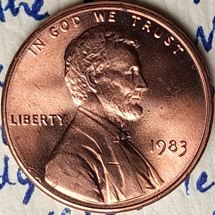 1983-P-Lincoln-Cent-With-A-Secondary,-Incuse-&-Inverted,-Trust-In-The-Corner-Of-The-Rim-And-Field.